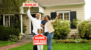 African American family celebrating purchase of home